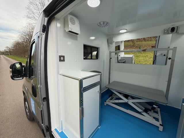 Adjustable grooming table inside the mobile spa